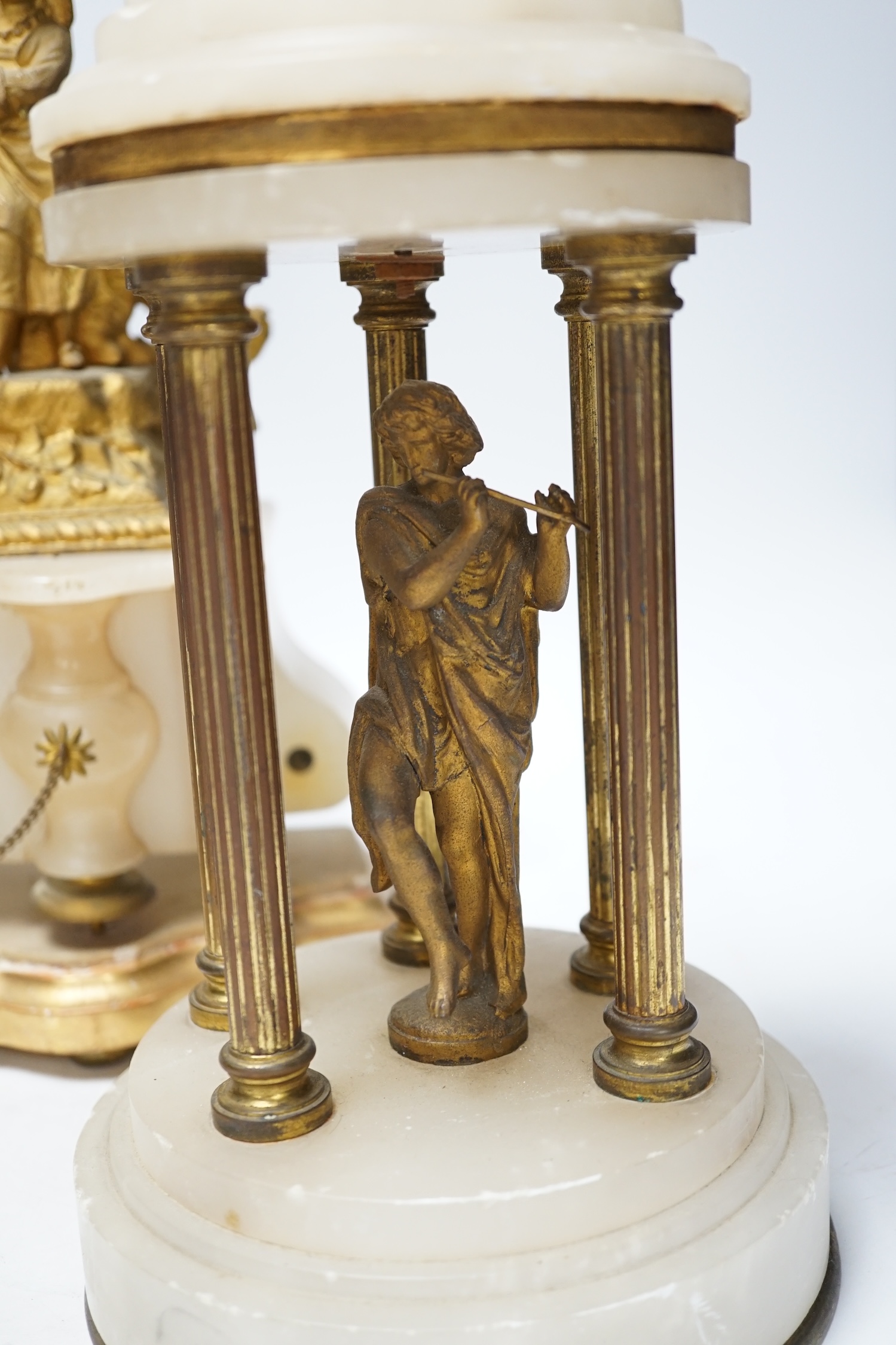 A French spelter and alabaster figural clock garniture, clock 23cm high